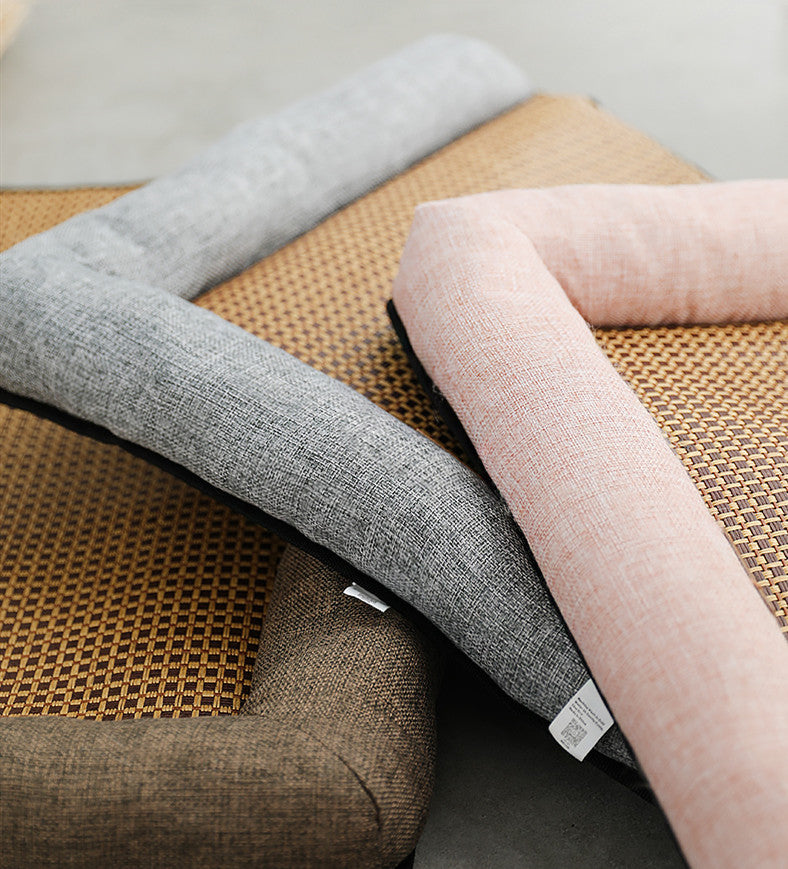 Three fabric Pet Mat in gray, pink, and brown on a woven surface.