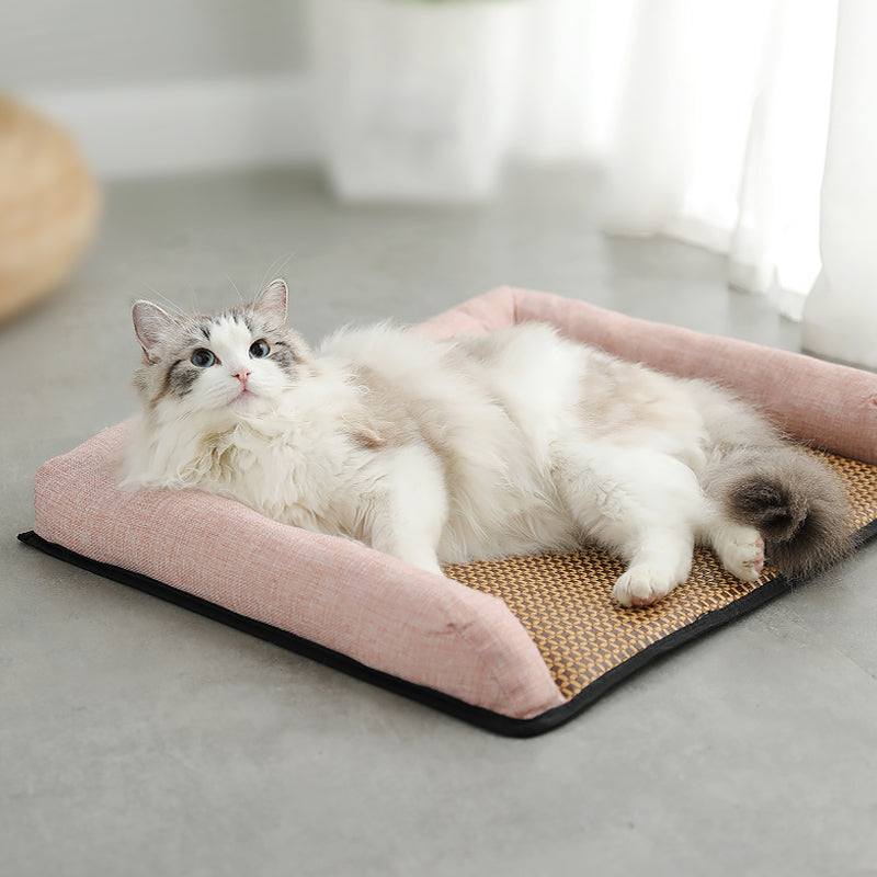 Cat lying on a pink Pet Mat with a scratching pad underneath