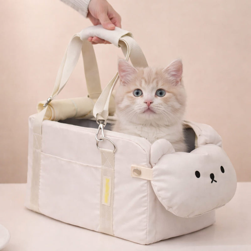 Cat sitting in a white Outdoor Cat Travel Bed with a plush toy on a light pink background