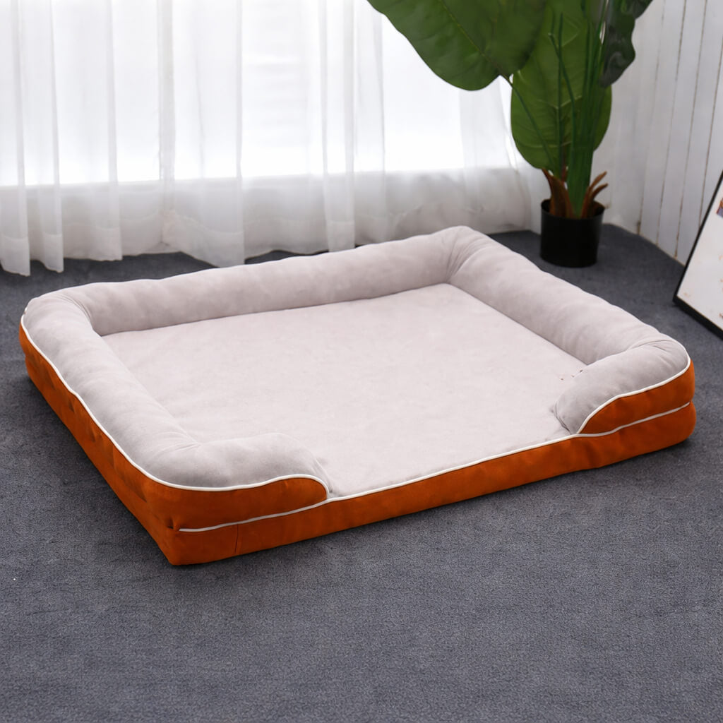 Orthopedic Dog Bed with orange and gray exterior on a carpeted floor.