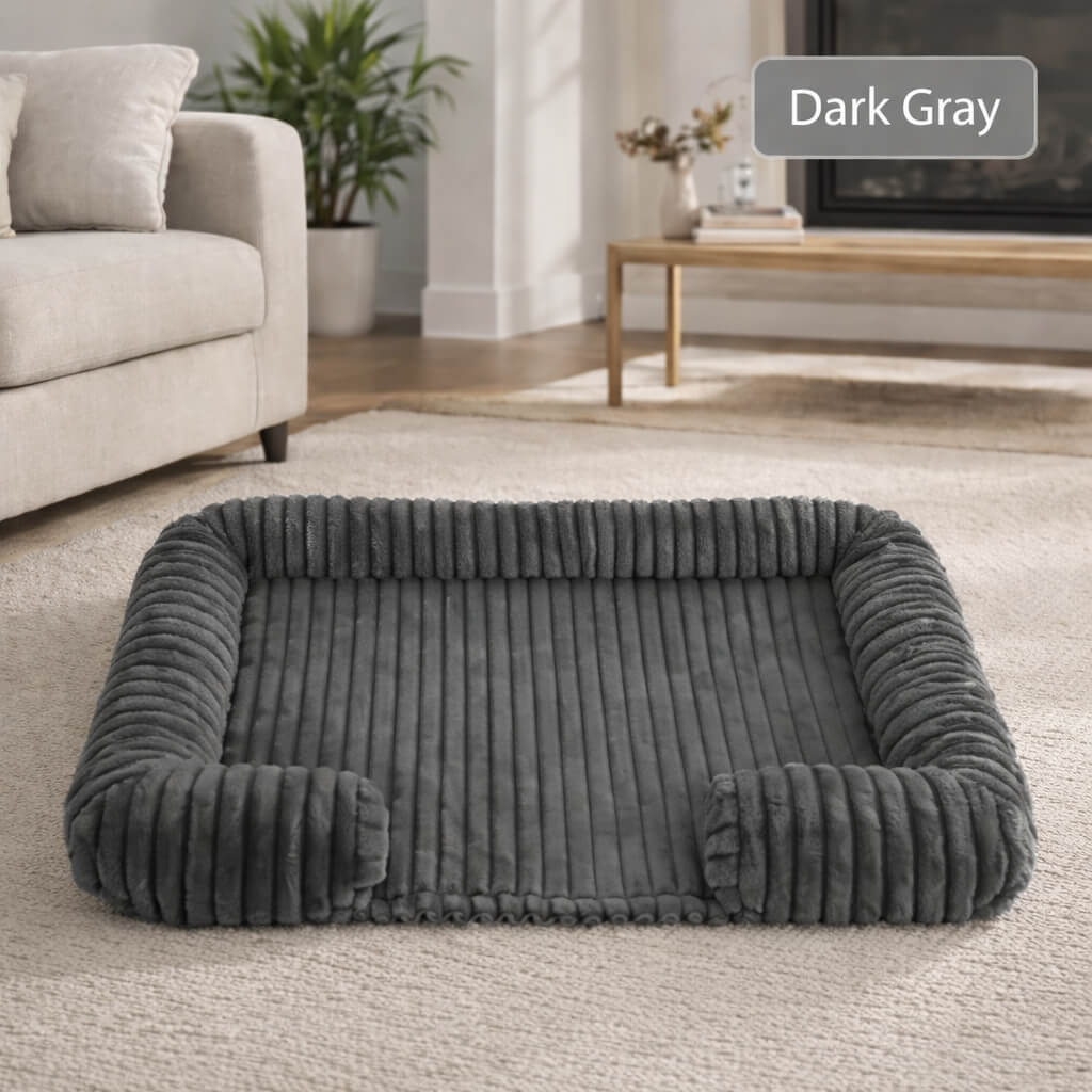 Dark gray Orthopedic Joint Support Dog Bed in a living room setting with a couch and fireplace.