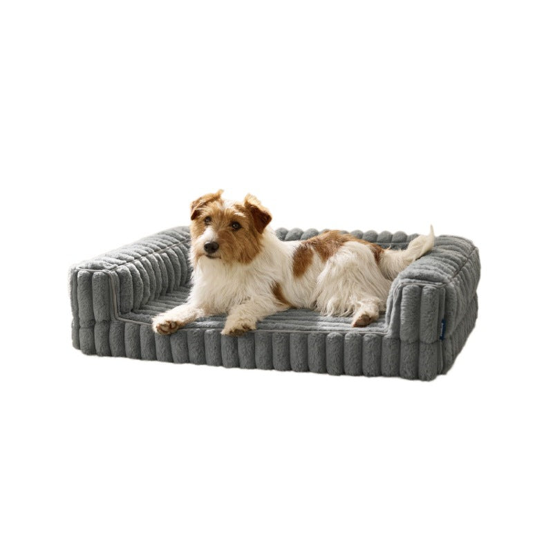 Dog lying on a gray Orthopedic Dog Bed with a white background
