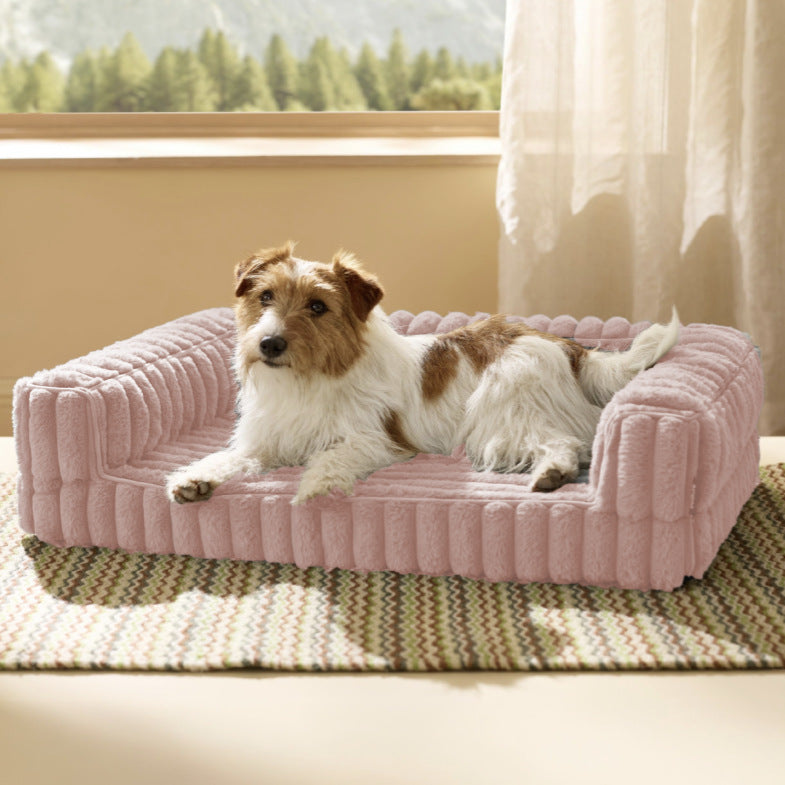 Dog lying on a pink Orthopedic Dog Bed in a room with a window and curtains.